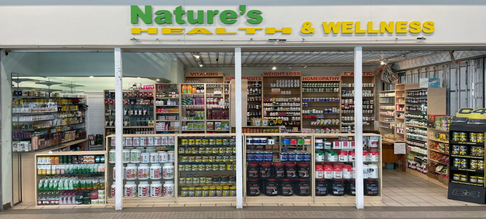 Nature's Health & Wellness store front with various products on shelves.